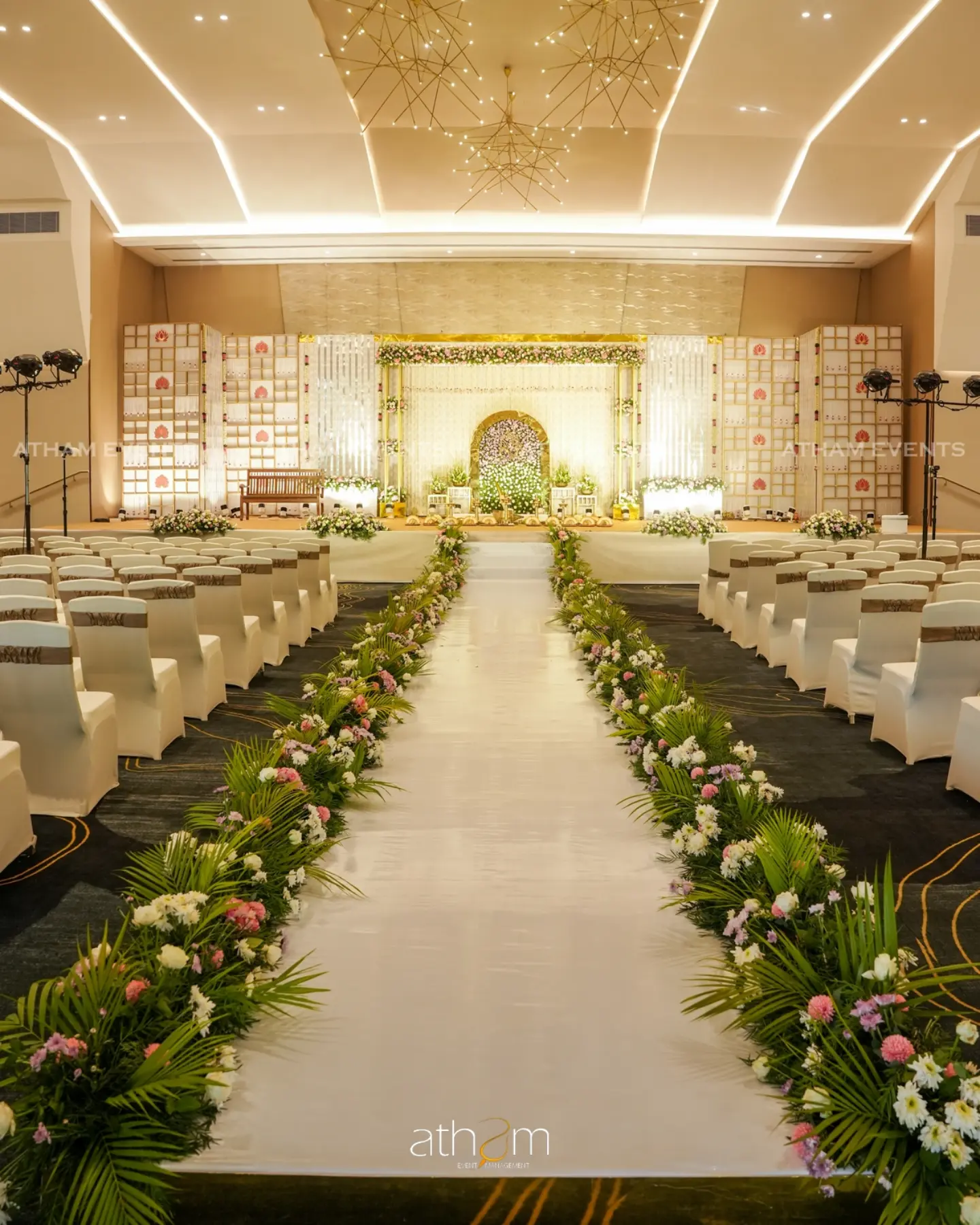 Grand illuminated wedding hall aisle and stage lighting setup